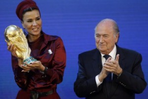 Sheikha Moza, wife of Qatar's Emir Sheikh Hamad, proudly presents a copy of the World Cup he received from FIFA President Blatter in Zurich